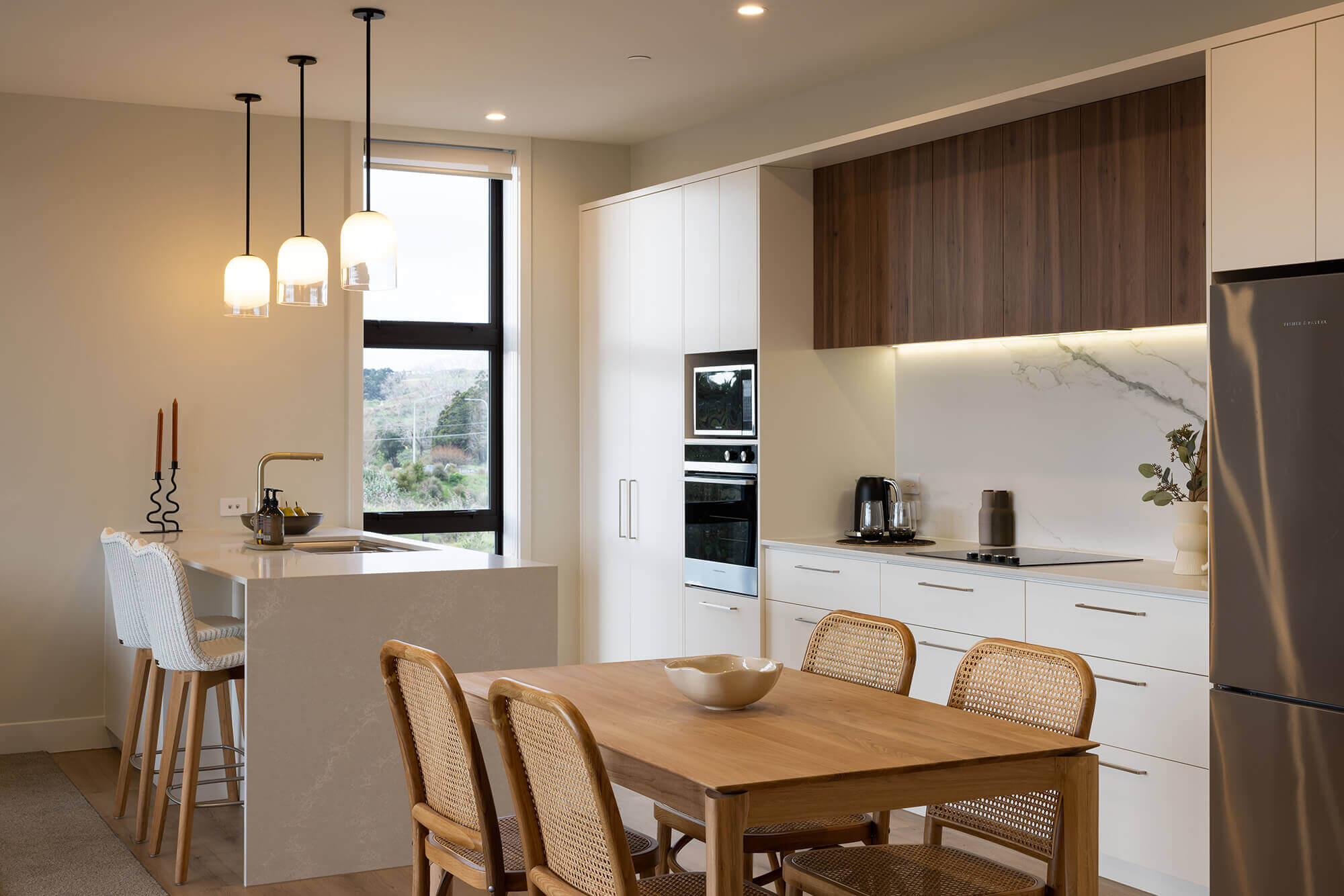 Kitchen and dining area with a breakfast bar at the island counter.