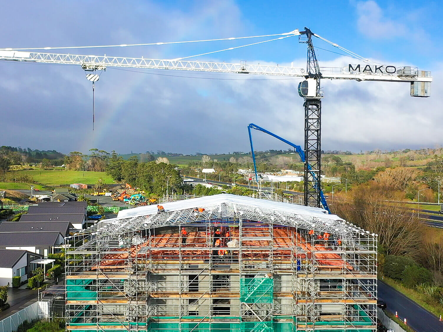 MAKO crane towers over Rimu Apartment building with roof tent being installed.