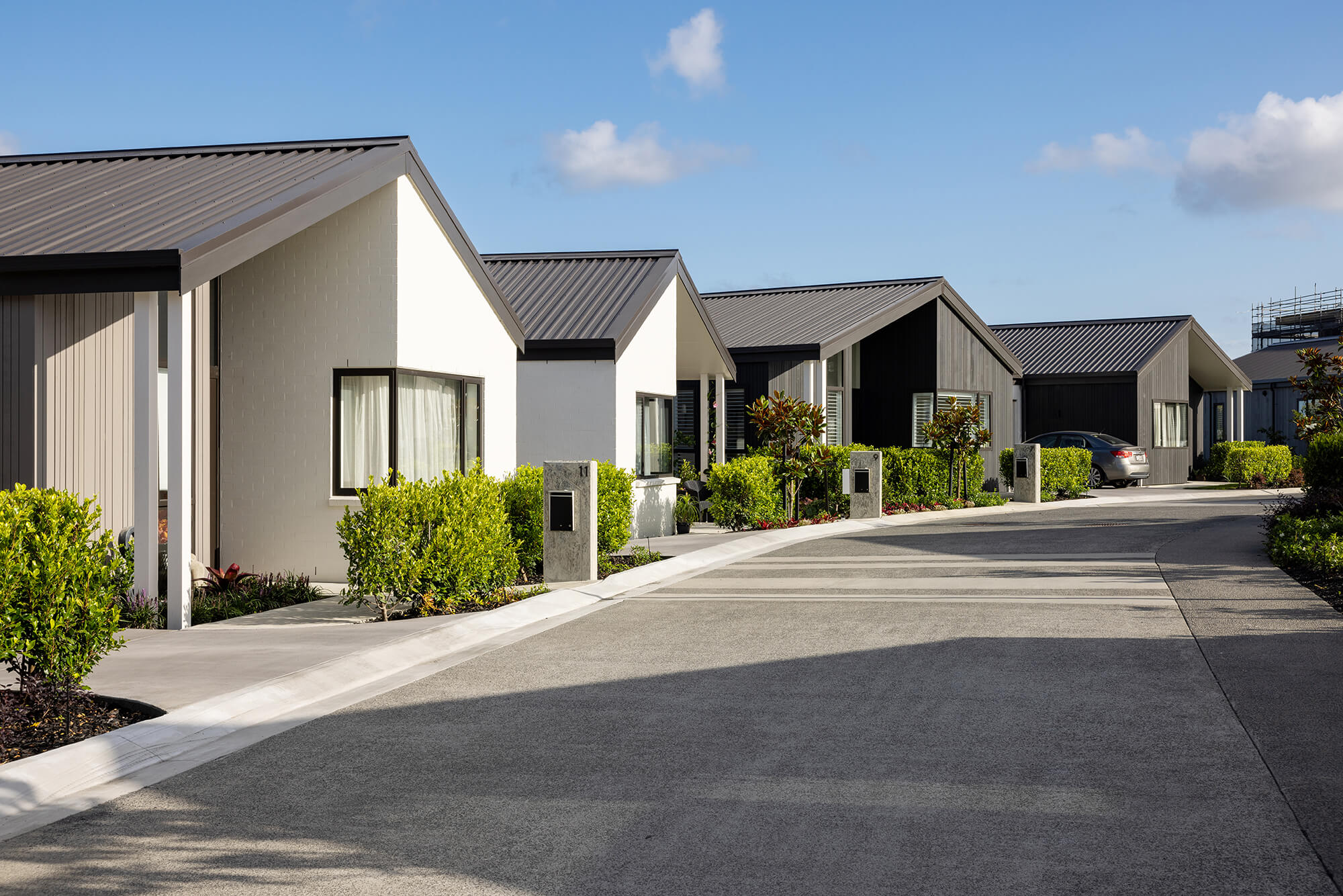 View down road with single storey villas lining the street.