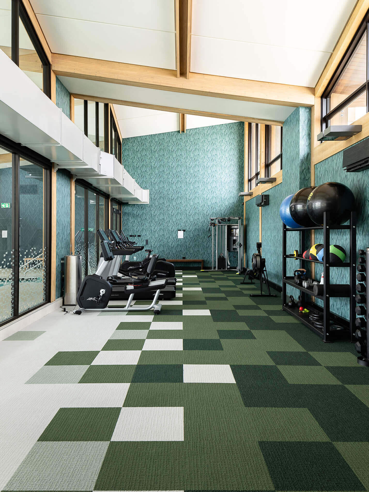 The gym space in the poolhouse is well-appointed with weights and cardio equipment.