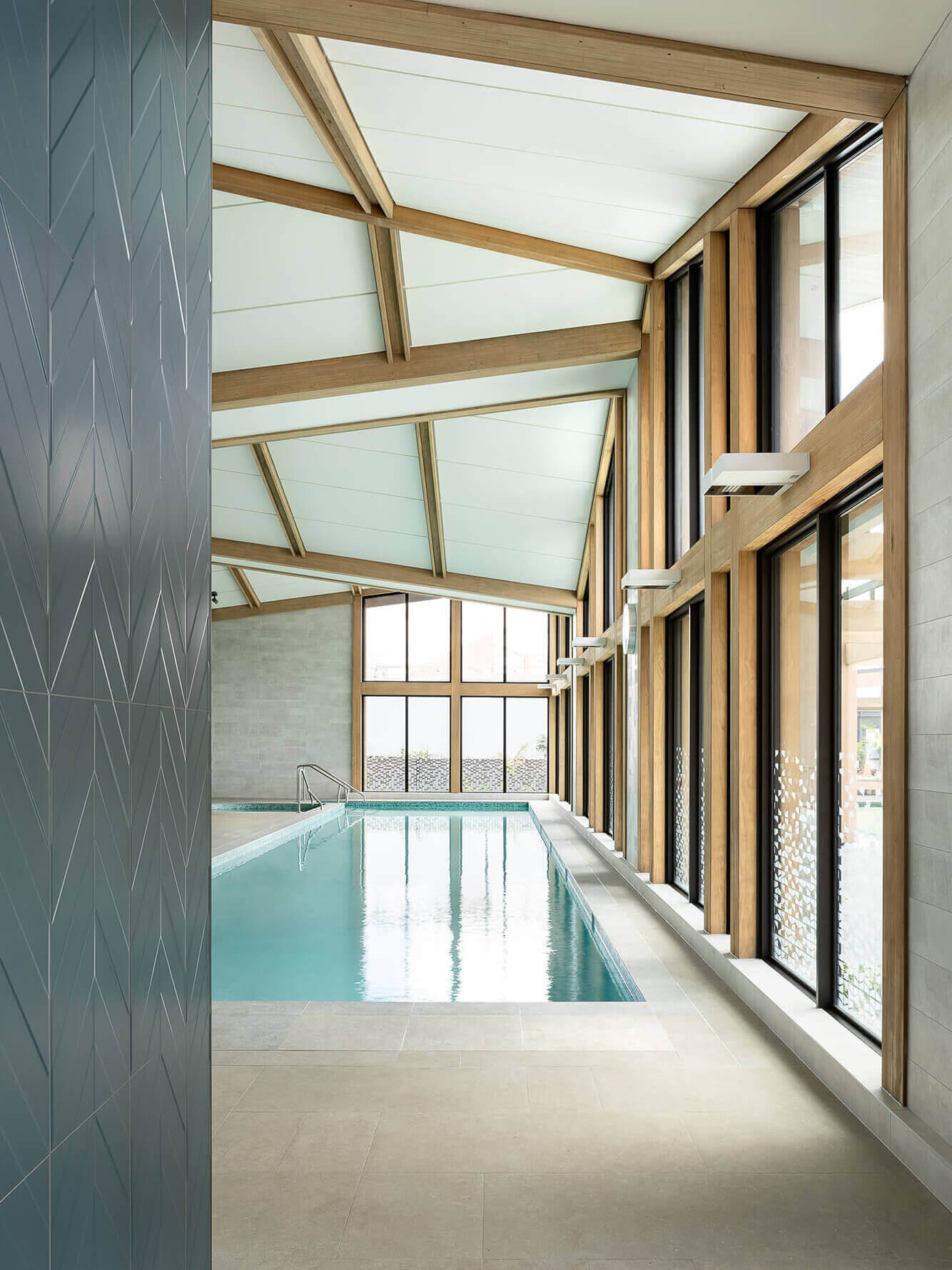 The poolhouse is a light-filled space with a 20 meter swimming pool and large windows.