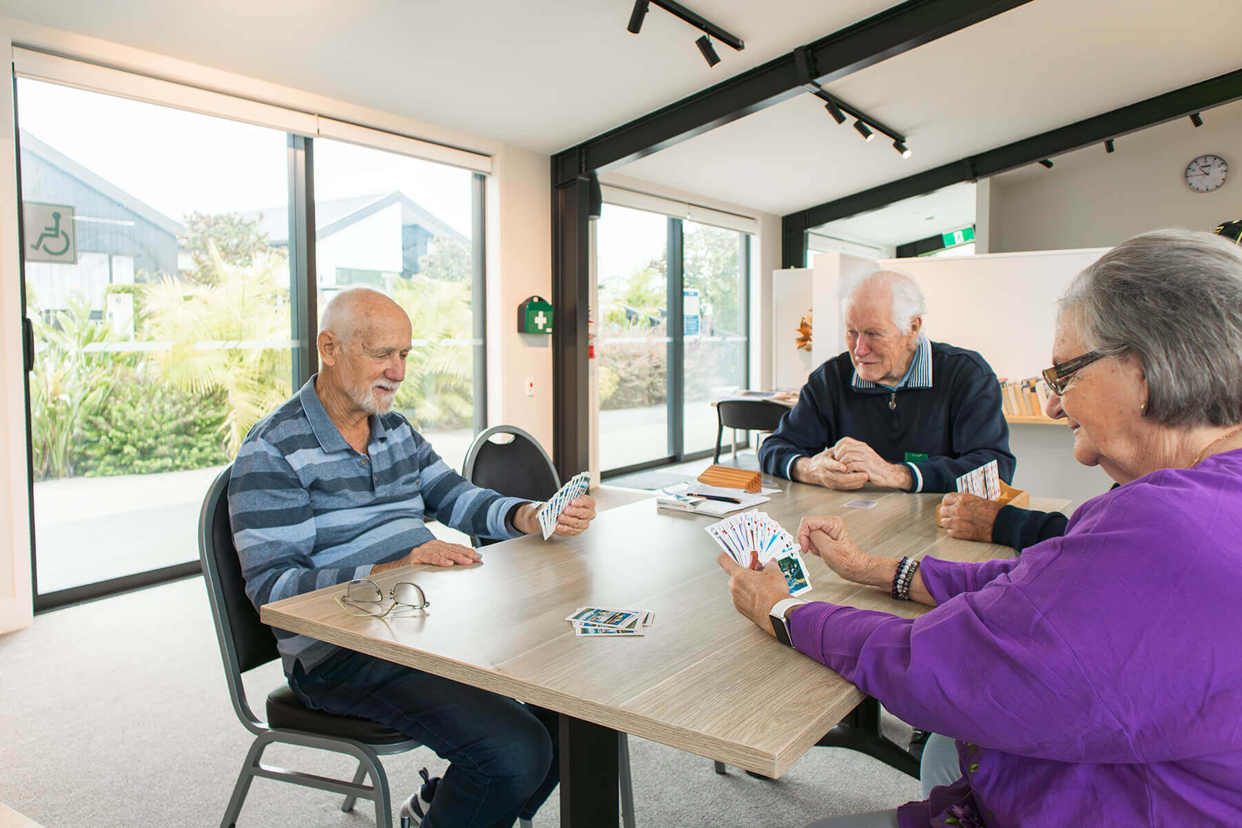 Residents playing 500 in The Hub